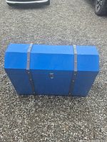 Full view of closed blue wooden toy chest