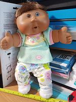 Full view standing of Cabbage Patch Kids doll with outfit