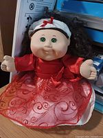 Full view of doll sitting, showing outfit and size context