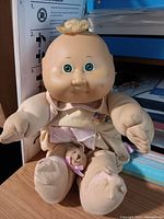 Full view of Cabbage Patch Kids Preemie doll seated