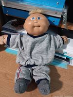 Full view of 12-inch Cabbage Patch Kids Preemie doll in grey sweatsuit