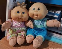 Both 10-inch Cabbage Patch Kids dolls seated side by side