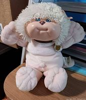 Full view of plush dog seated on table