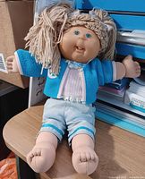 Full view of 16-inch Cabbage Patch Kids doll with blue jacket and shorts
