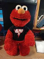 Red Elmo plush with black shirt front view