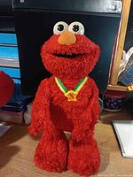Plush red Elmo with medal