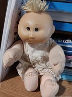 Full view of Cabbage Patch Kids Preemie doll sitting upright