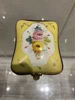 Top view showing yellow body with floral painting and shape