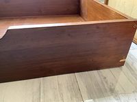 Side close-up showing wood grain and corner hardware