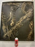 Front view of framed impasto abstract painting with soda can for scale