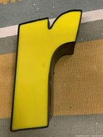 Front view of yellow lower-case r showing overall design and color