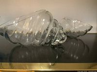 Pair of clear glass shell-shaped bowls side view