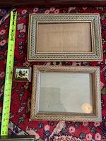 Two khatam kari frames and small box alongside tape measure for scale