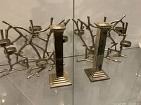 Front view of two branch-form five-light candleholders and two column candleholders