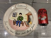 Front view of plate beside Coca-Cola can for scale