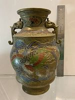 Front view of cloisonné vase with ruler for scale