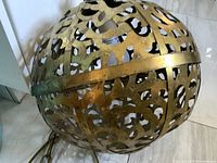 Full view of brass pierced globe lamp