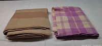Both blankets folded side by side