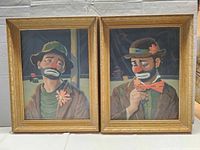 Both framed sad clown paintings front view