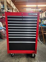 Front view showing nine drawers, drawer pulls, lock, branding