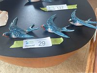 All three Beswick swallow plaques on table