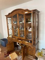 Full view of two-piece Peppler wooden china cabinet with upper glass hutch and lower buffet