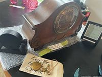 Group shot showing mantle clock, desk clock, weather station and key