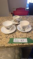 All three teacup and saucer sets displayed on countertop