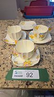 Overview of three cup and saucer sets plus extra saucer