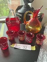 Group view of pitcher, purse and five cups