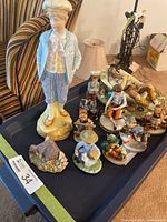 Tray with Hummels, large porcelain boy, stone cottage and assorted figurines