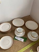 All pieces arranged: two cups, two saucers, six side plates stacked, two luncheon plates