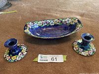 All three Maling pieces: oval dish centered, two candlesticks flanking
