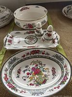 Group shot: oval serving bowl, rectangular cake plate with salt and pepper shakers, round open serving bowl behind