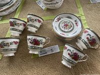 Six teacups and stacked saucers showing full set
