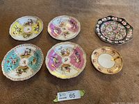 All six plates laid out on carpet showing size and variety