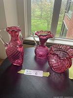 Overview of all three ruby glass pieces on table