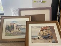 Three frames, two with paintings, one empty