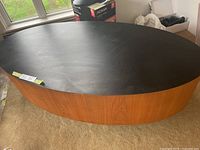 Oblique view showing black top and wood veneer base