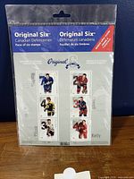 Front of sealed stamp pane showing six individual player stamps