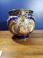 Front view showing Neoclassical panel, gilt scrollwork and cobalt glaze