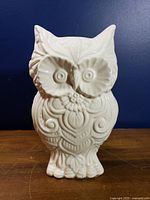 front view of glossy white ceramic owl figurine