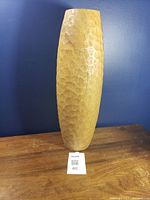 Front view of hand-carved wooden floor vase