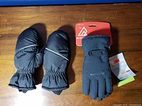 Ripzone gloves with tags and unbranded mittens side by side