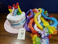 Hat and leis arranged on table
