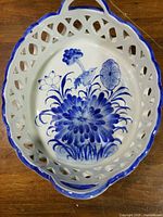 Top view showing hand-painted cobalt floral and pierced rim
