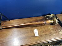 Full view of torch-style wall sconce laid flat showing entire length