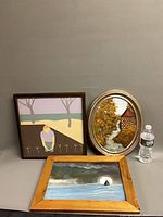 All three framed oil paintings with water bottle for scale