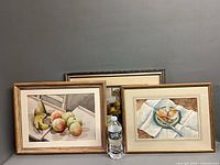 Group shot of all three framed watercolors with bottle for scale