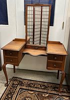 Full view of antique wooden vanity with central mirror, two drawer pedestals and cabriole legs
